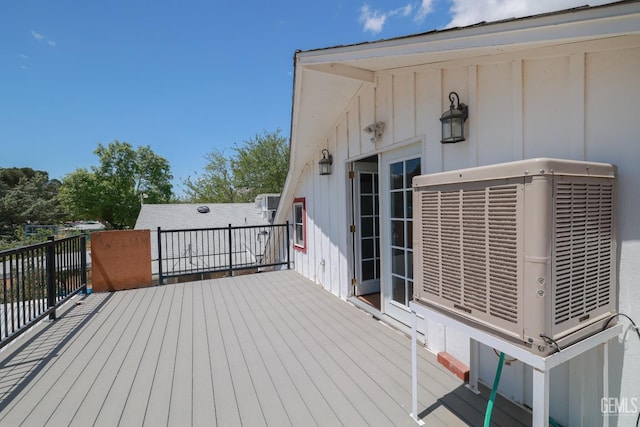 wooden terrace featuring central AC unit