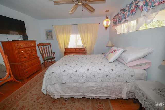 bedroom with a ceiling fan and wood finished floors