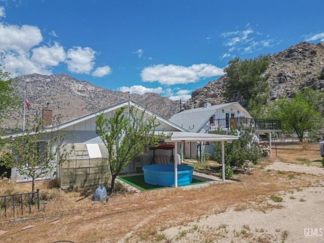 rear view of house featuring a chimney and a mountain view