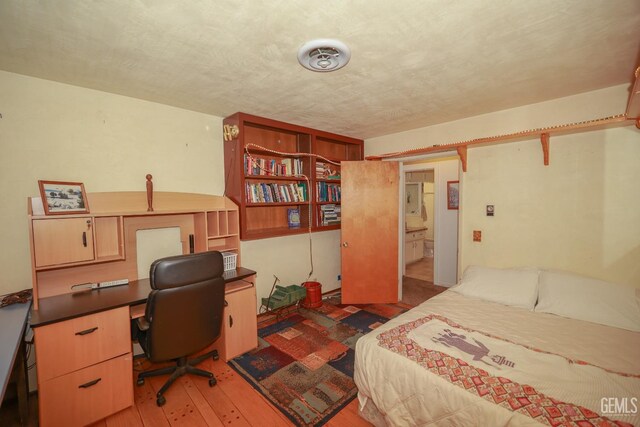 bedroom with hardwood / wood-style floors
