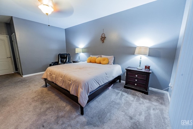 carpeted bedroom with ceiling fan and baseboards