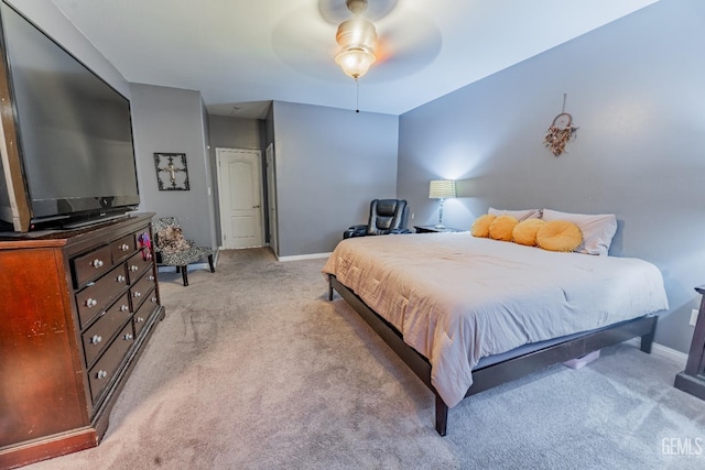 bedroom with a ceiling fan, light colored carpet, and baseboards