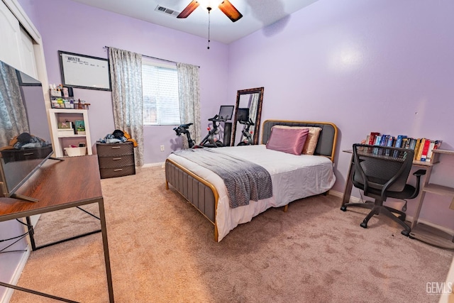 bedroom with light carpet, ceiling fan, visible vents, and baseboards