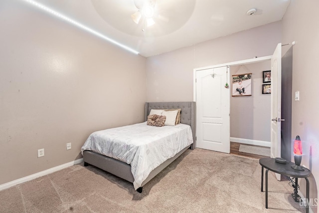 bedroom featuring carpet, a ceiling fan, and baseboards