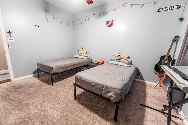 carpeted bedroom with a ceiling fan and baseboards