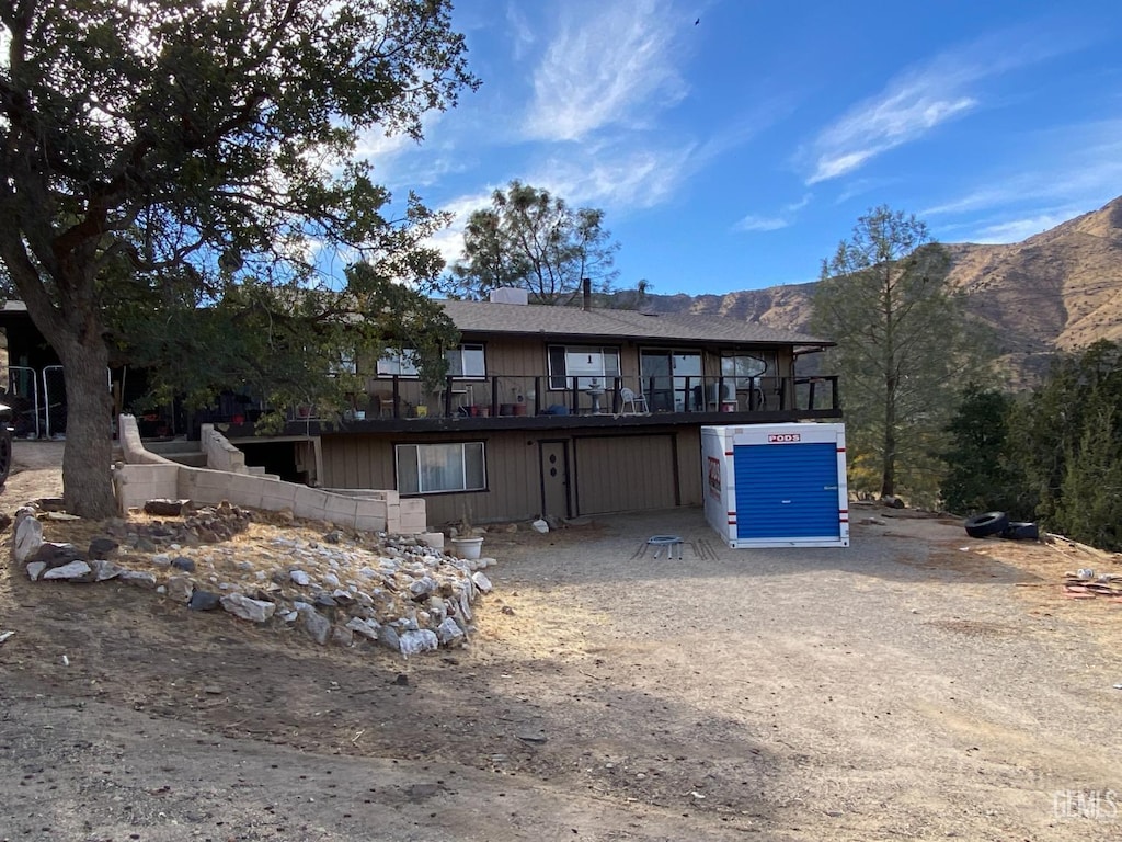 back of property with a mountain view