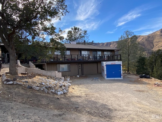 back of property with a mountain view