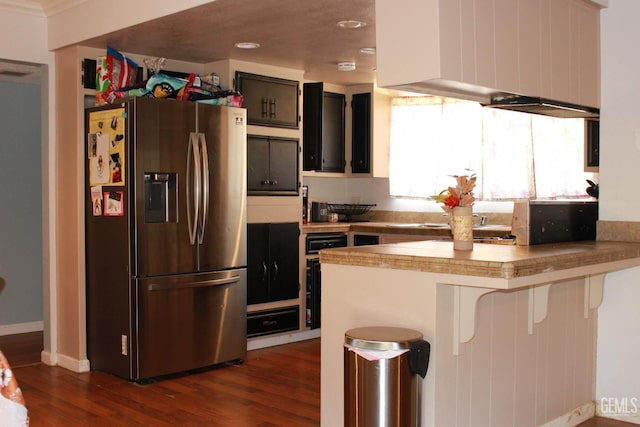 kitchen with a kitchen breakfast bar, dark hardwood / wood-style floors, stainless steel fridge with ice dispenser, and kitchen peninsula