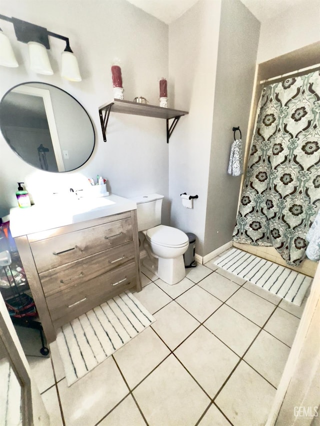 bathroom featuring tile patterned floors, vanity, toilet, and walk in shower