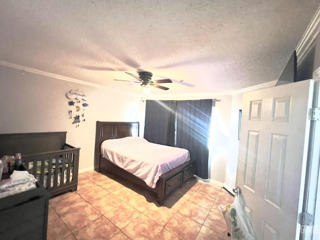 tiled bedroom with a textured ceiling, ceiling fan, and ornamental molding