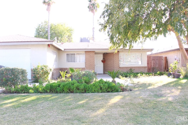 ranch-style home with a front lawn and a garage