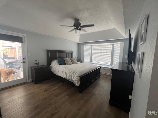 bedroom featuring multiple windows, a ceiling fan, a textured ceiling, and dark wood finished floors