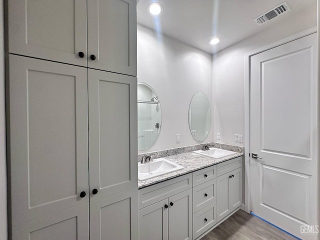 11118 Irontooth Ave, Bakersfield, CA 93311 - full bath with double vanity, wood finished floors, and recessed lighting