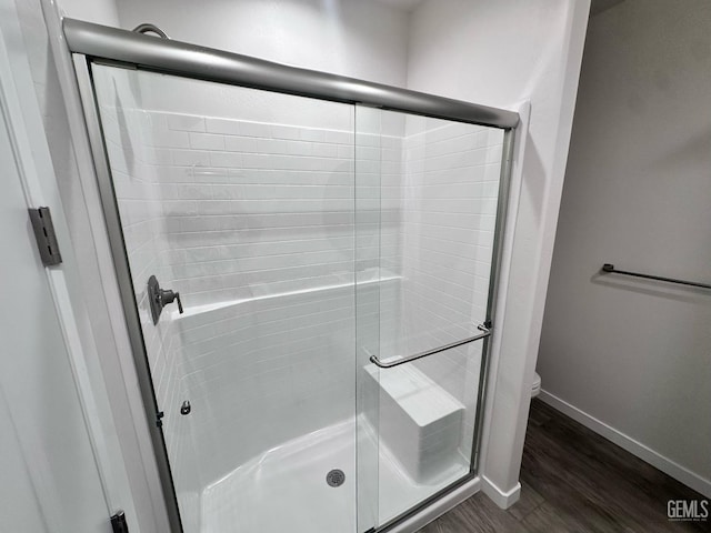 11118 Irontooth Ave, Bakersfield, CA 93311 - full bath featuring a stall shower, toilet, wood finished floors, and baseboards