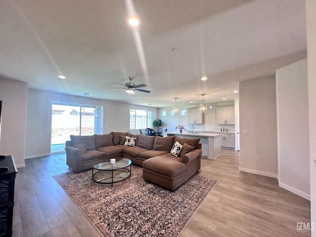 11118 Irontooth Ave, Bakersfield, CA 93311 - living room featuring recessed lighting, light wood-type flooring, ceiling fan, and baseboards