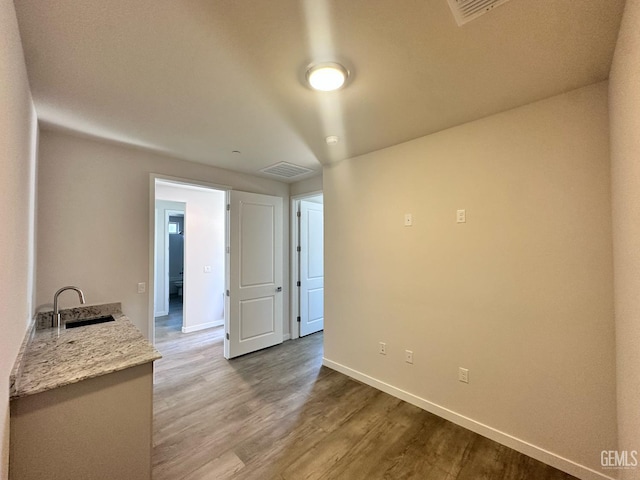 11118 Irontooth Ave, Bakersfield, CA 93311 - spare room with a sink, wood finished floors, and baseboards