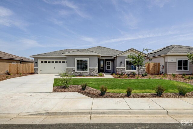 11118 Irontooth Ave, Bakersfield, CA 93311 - view of front of property with stone siding, stucco siding, concrete driveway, a garage, and a tiled roof