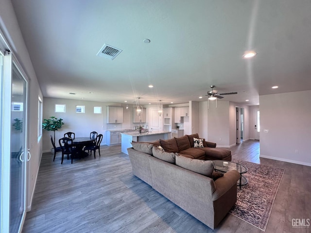 11118 Irontooth Ave, Bakersfield, CA 93311 - living area featuring recessed lighting, wood finished floors, a ceiling fan, and baseboards