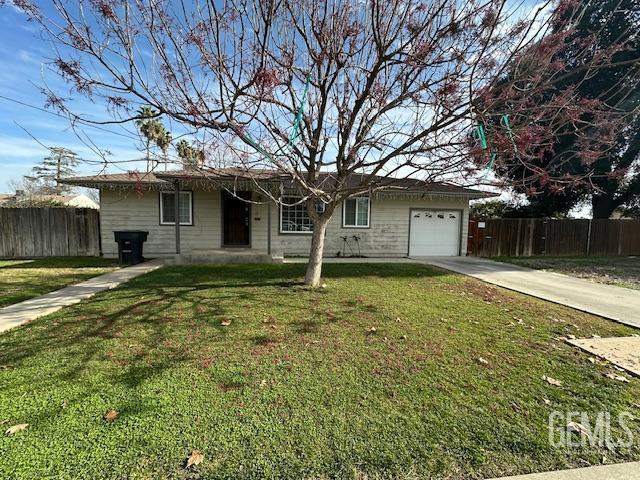 single story home featuring a front lawn and a garage