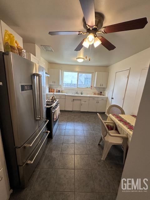 kitchen featuring white cabinets, ceiling fan, sink, and appliances with stainless steel finishes