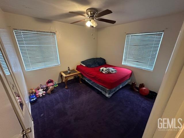 carpeted bedroom with ceiling fan