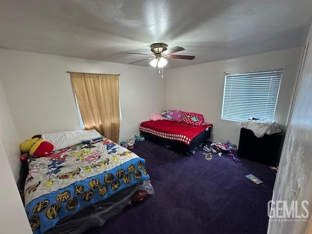 carpeted bedroom featuring ceiling fan