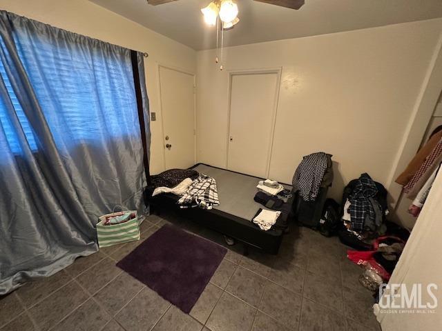 tiled bedroom with ceiling fan