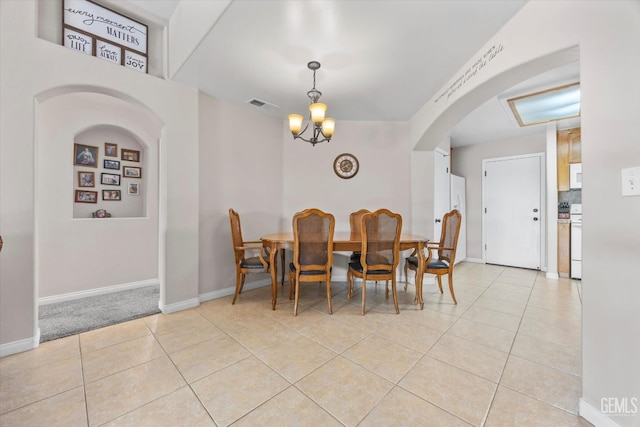 3601 Villa Lante St, Bakersfield, CA 93308 - dining space featuring arched walkways, light tile patterned flooring, and a chandelier