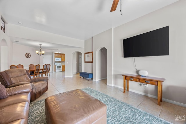 3601 Villa Lante St, Bakersfield, CA 93308 - tiled living area featuring arched walkways, a chandelier, and a ceiling fan