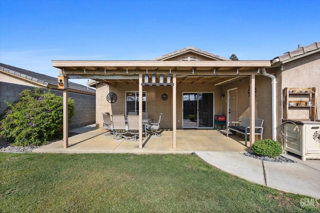 3601 Villa Lante St, Bakersfield, CA 93308 - back of house with stucco siding, a patio, and a lawn