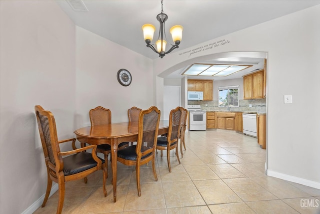 3601 Villa Lante St, Bakersfield, CA 93308 - dining room with arched walkways, a chandelier, and light tile patterned floors
