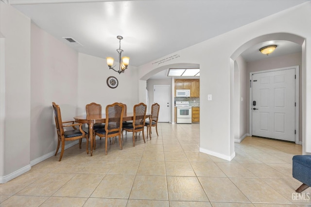 3601 Villa Lante St, Bakersfield, CA 93308 - dining room with arched walkways, light tile patterned flooring, and a chandelier