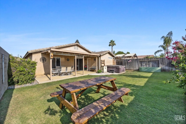 3601 Villa Lante St, Bakersfield, CA 93308 - rear view of property featuring a hot tub, a patio, stucco siding, and a fenced backyard