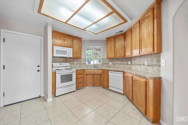 3601 Villa Lante St, Bakersfield, CA 93308 - kitchen featuring white appliances, decorative backsplash, light countertops, and light tile patterned floors