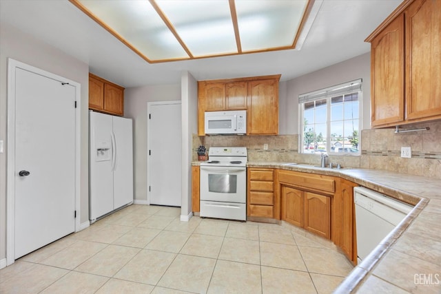 3601 Villa Lante St, Bakersfield, CA 93308 - kitchen featuring white appliances, decorative backsplash, light countertops, brown cabinetry, and light tile patterned floors