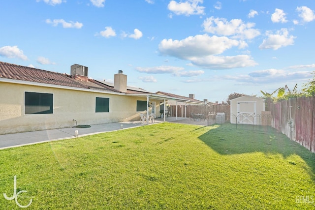 view of yard with a patio, a fenced backyard, a shed, and an outdoor structure