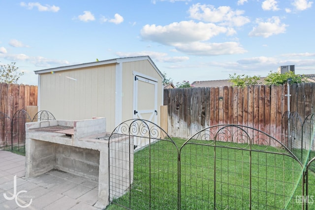 view of shed with a fenced backyard