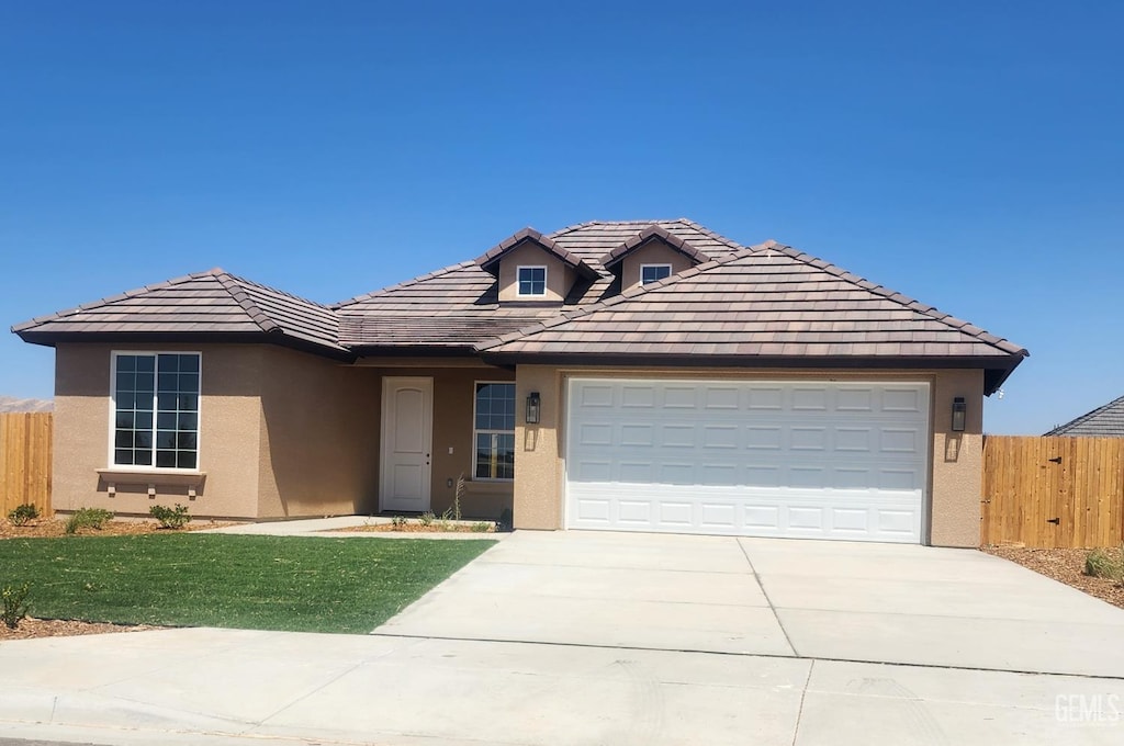 4617 Freestone Ct, Bakersfield, CA 93306 - view of front of house with stucco siding, driveway, an attached garage, and a tiled roof