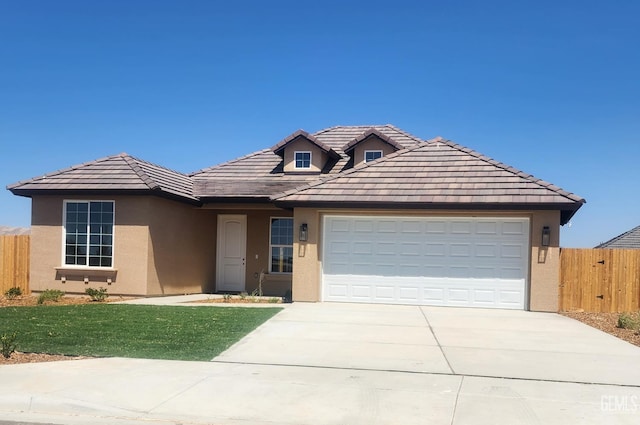 4617 Freestone Ct, Bakersfield, CA 93306 - view of front of house with stucco siding, driveway, an attached garage, and a tiled roof