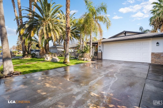 view of front of property with a garage and a front lawn