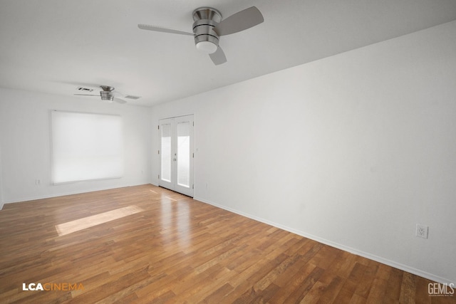 empty room with ceiling fan, french doors, and light wood-type flooring