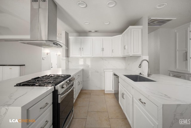 kitchen with white cabinetry, sink, wall chimney exhaust hood, stainless steel appliances, and light stone counters