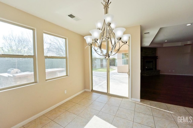 unfurnished dining area with a brick fireplace and light tile patterned floors