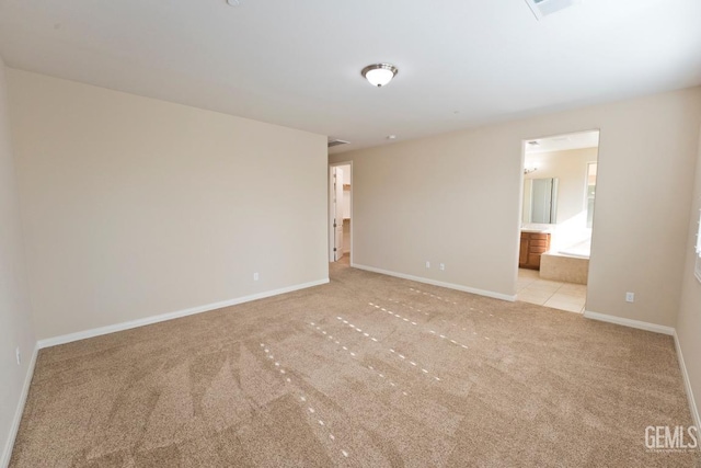 unfurnished room featuring light carpet