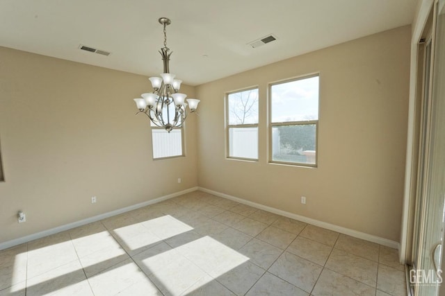 unfurnished room featuring a chandelier and light tile patterned floors