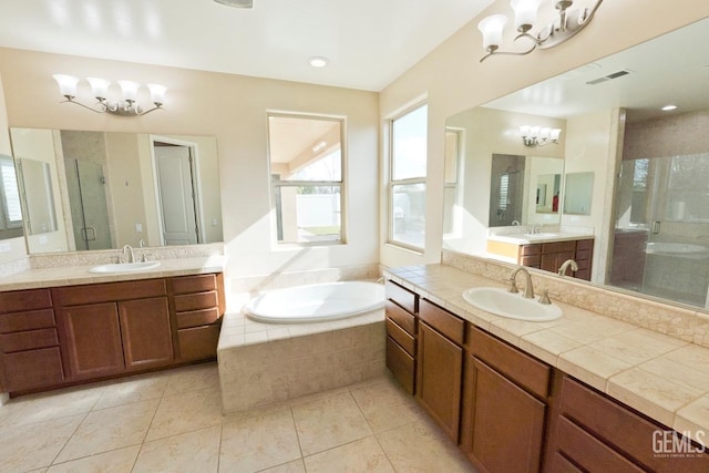 bathroom featuring tile patterned floors, vanity, plus walk in shower, and a notable chandelier