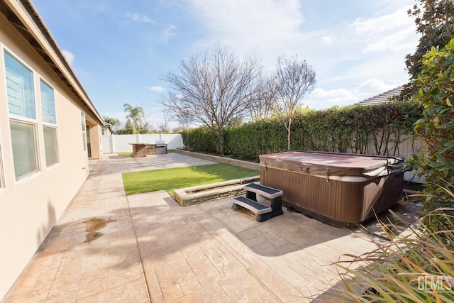 view of patio / terrace with a hot tub