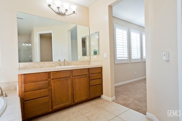 bathroom featuring a relaxing tiled tub, tile patterned floors, and vanity