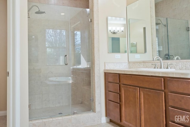 bathroom featuring vanity and a shower with shower door