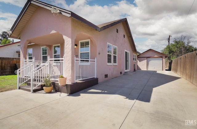 814 Eureka St, Bakersfield, CA 93305 - view of front of house featuring a porch, concrete driveway, stucco siding, a detached garage, and an outdoor structure
